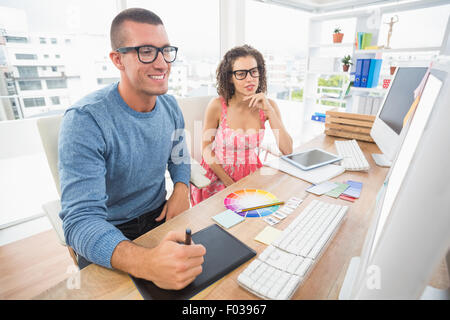 Concentrated coworkers using laptop and digitizer Stock Photo
