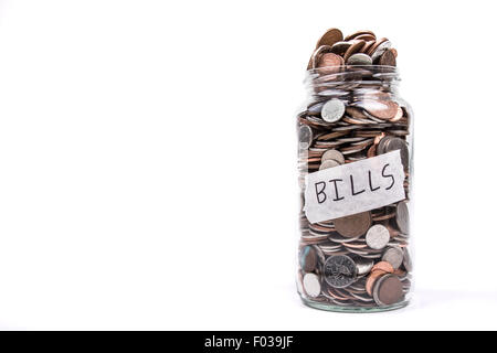 An Overflowing Change Jar Labeled Bills Stock Photo