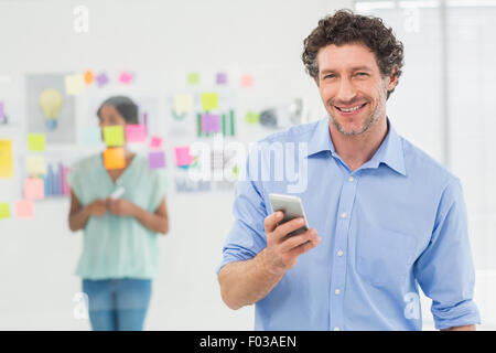 Businessman calling while his colleague posing Stock Photo