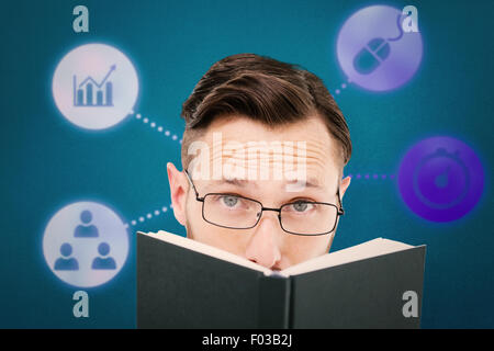 Composite image of young geek looking over black book Stock Photo