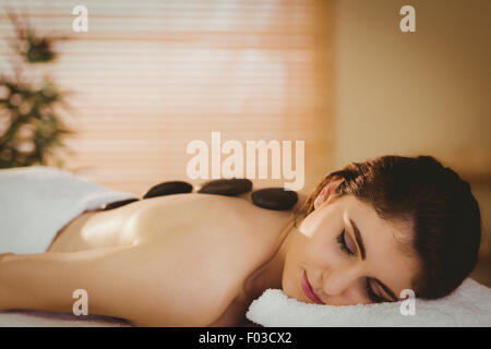 Young woman getting a hot stone massage Stock Photo