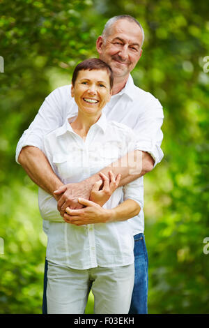 Happy senior couple standing together in nature Stock Photo