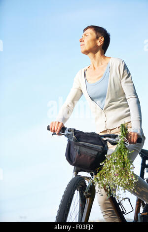 Senior woman on a bike Stock Photo - Alamy
