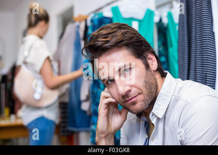 Bored man sitting in front of his girlfriend Stock Photo