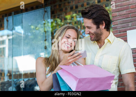 Laughing couple using smartphone Stock Photo