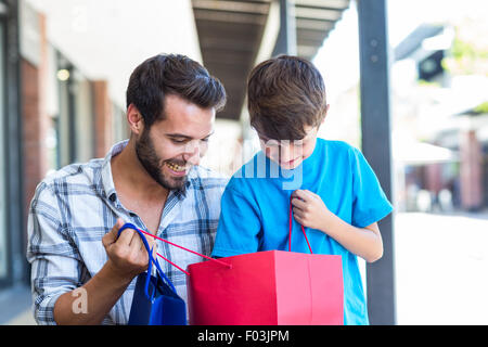 A father and his son looking into the bag Stock Photo