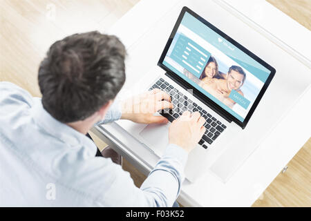 Composite image of couple using laptop Stock Photo - Alamy