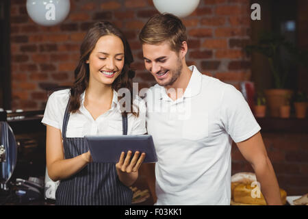 Smiling co-workers using a tablet Stock Photo