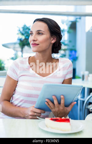 Happy woman enjoys using her tablet Stock Photo