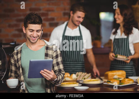 Smiling customer looking at tablet Stock Photo