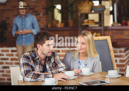 Two smiling friends talking and drinking coffee Stock Photo