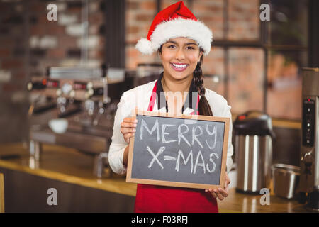 Pretty waitress with a chalkboard merry x-mas Stock Photo