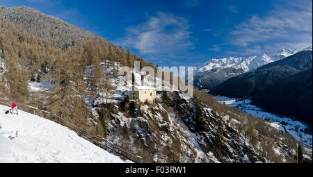 Italy,Lombardy,Retiche Alps,Camonica Valley,snowshoeing along the trail to the ancient alpine church of San Clemente ,twelfth Stock Photo