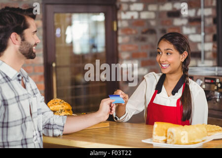 Customer handing a credit card to the waitress Stock Photo