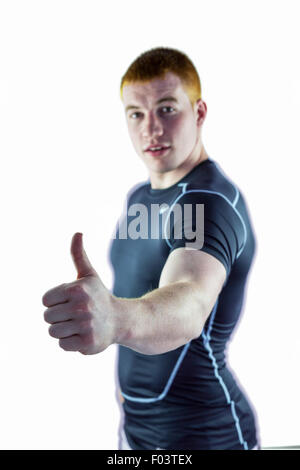 Muscular rugby player gesturing thumbs up Stock Photo - Alamy