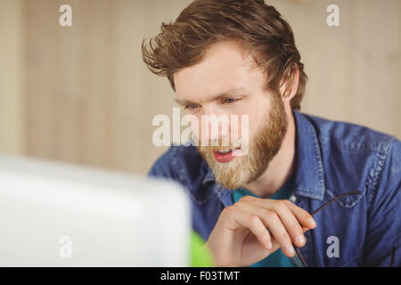 Focused hipster working at his desk Stock Photo