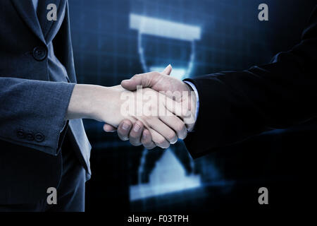 Composite image of close up of two businesspeople shaking their hands Stock Photo