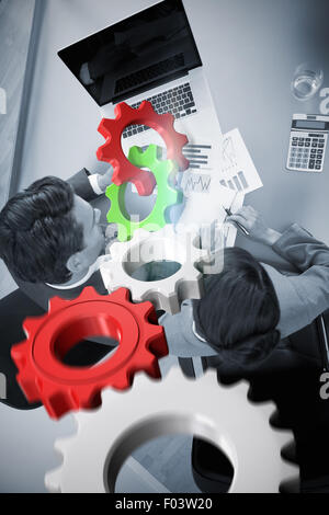 Composite image of white and red cogs and wheels Stock Photo