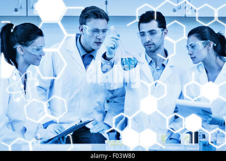 Composite image of scientists working on an experiment at the laboratory Stock Photo