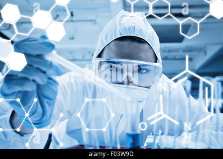 Composite image of close up of a protected science student dropping liquid in a test tube Stock Photo