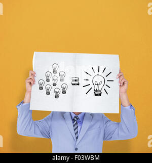 Composite image of portrait of a businessman hiding his face behind a blank panel Stock Photo