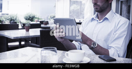 Focused young businessman working on tablet Stock Photo