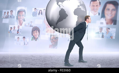 Composite image of businessman carrying the world Stock Photo