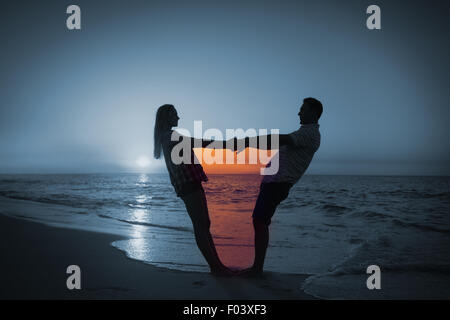 Composite image of couple holding hands on balcony Stock Photo