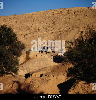 Woman at the well, Berber village of Matmata, Sahara Desert, Tunisia. Stock Photo