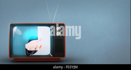 Composite image of businessman presenting with his hand Stock Photo