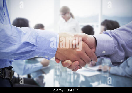 Composite image of two men shaking hands Stock Photo