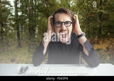 Composite image of businessman yelling with his hands on face Stock Photo