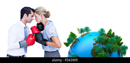 Composite image of business people wearing and boxing red gloves Stock Photo