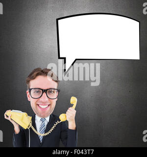 Composite image of geeky businessman holding phone Stock Photo