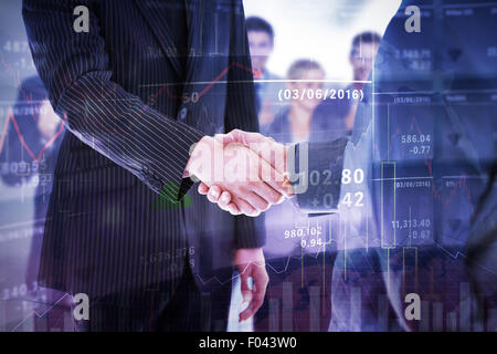 Composite image of business people shaking hands Stock Photo