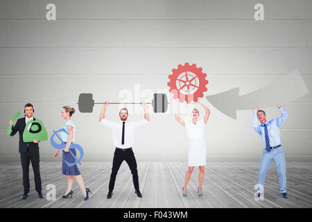 Composite image of business people holding icons Stock Photo