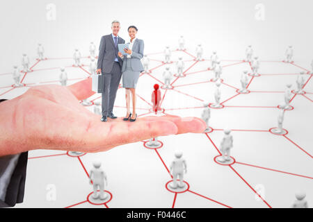 Composite image of business people using tablet computer Stock Photo