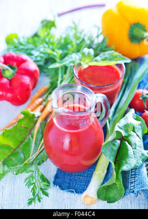 fresh vegetable juice in the glass and on a table Stock Photo