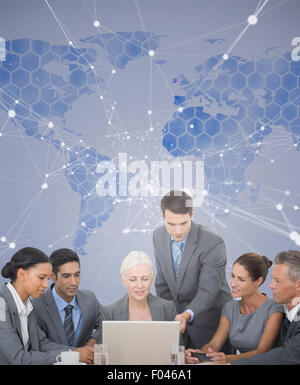 Composite image of business people using laptop Stock Photo