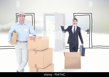 Composite image of handsome delivery man leaning on stacked cardboard boxes Stock Photo