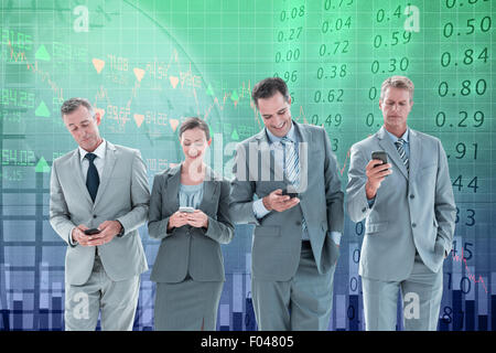 Composite image of employees using their mobile phone Stock Photo