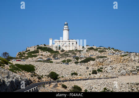 Lighthouse at Cap de Formentor during the busy tourist season.  Cars queuing up the narrow mountain roads. Stock Photo