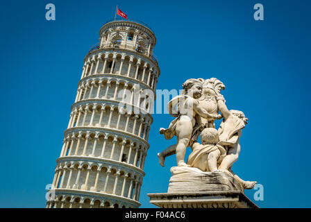 Leaning tower of Pisa and a nearby Putti fountain. Stock Photo