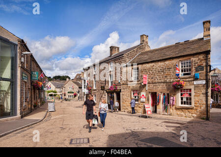 Young couple chatting and walking through Portland Square, Bakewell, Derbyshire, England Stock Photo