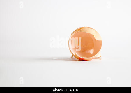 Cracked and empty egg on a white background Stock Photo