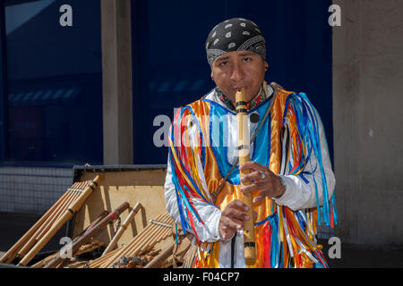 Foreign Street Aztec Flute Musicians in National Costume Playing South American Instruments. Soul Musician busker, pipe instrument, music, play flute, whistle, musical, pan, sound, bamboo blowing, indian, Peruvian, ethnic, native, pan pipe, people in traditional costume in Blackpoool, UK Stock Photo