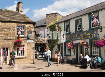 Visitors in Portland Square and the Bakewell Pudding Factory, Bakewell, Derbyshire, England, UK Stock Photo