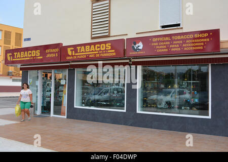 Woman coming out of a Tobacco Shop in Spain. These shops also sell postage stamps. Stock Photo