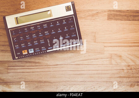 HP-12C Hewlett-Packard rpn financial calculator on a natural wood table top background Stock Photo