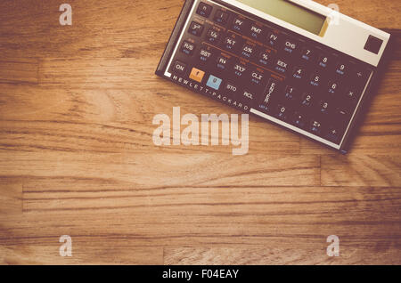 HP-12C Hewlett-Packard rpn financial calculator on a natural wood table top background Stock Photo